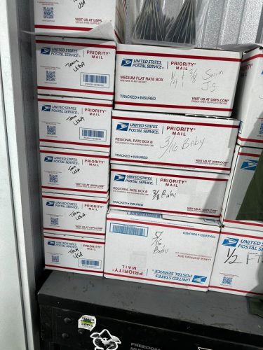 USA Bass Team order of boxes of D&L Tackle Advanced Jigs. Stack of boxes being shipped via USPS.